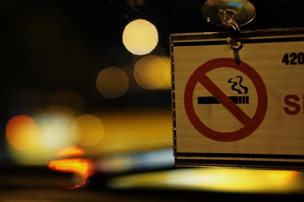 Close-up of no smoking sign at street