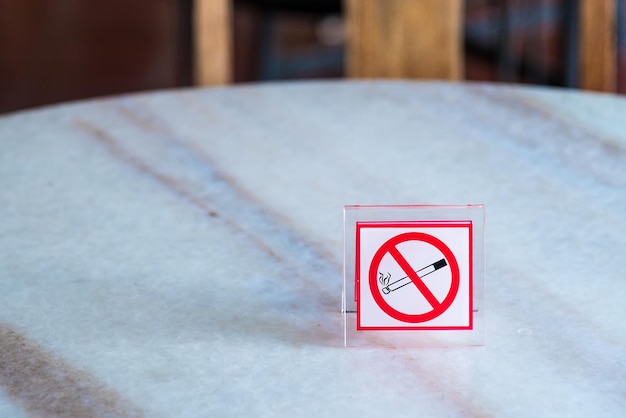 Close-up of no smoking sign on table