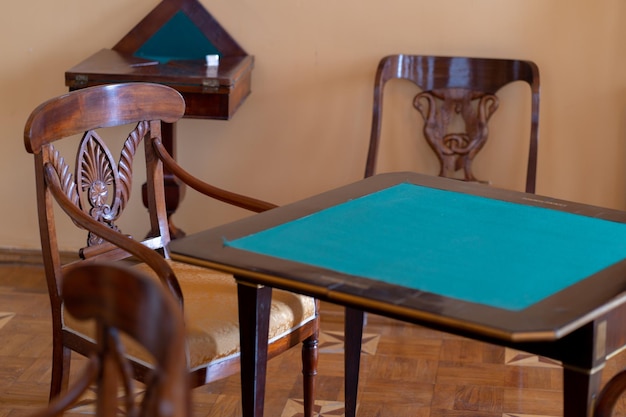 Close up of old chair and table indoors Oldfashioned exhibits in museum