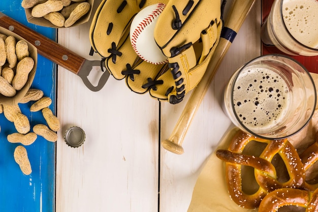 Close up of old worn baseball equipment on a wooden background.