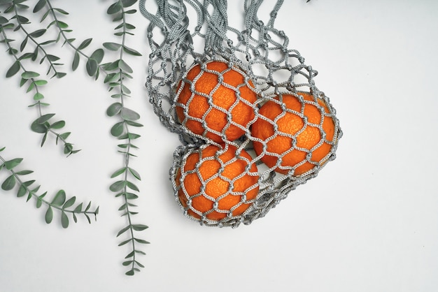 Close up onoranges in eco string bag