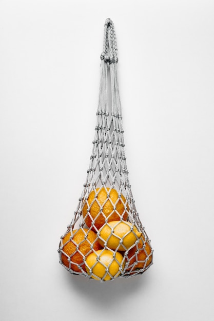 Close up on oranges in eco string bag