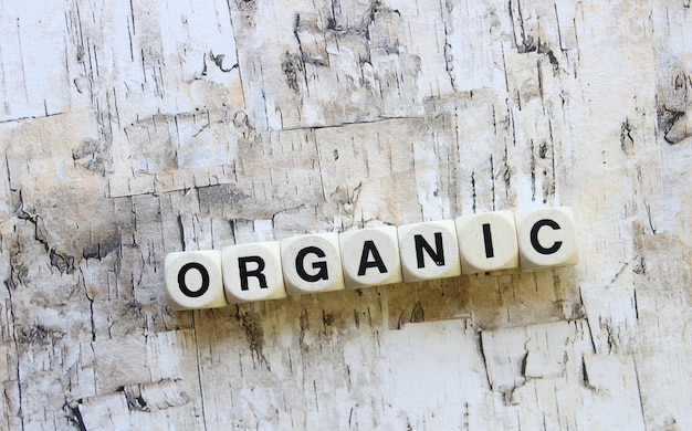 Photo close-up of organic text made from dice on wooden table