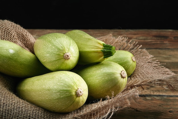 Close up on organic white zucchini on a wooden background