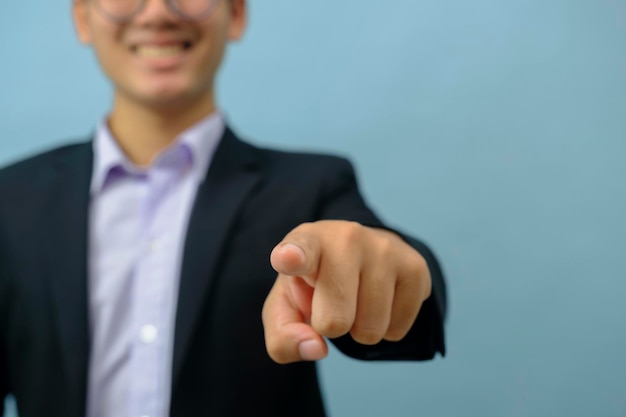 Close up ortrait of businessman pointing at camera