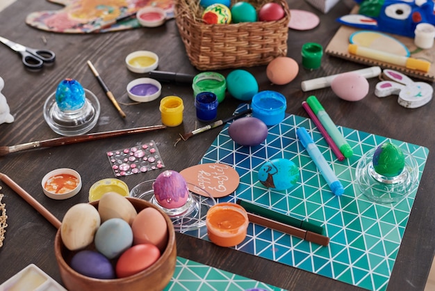 Close-up of painted Easter eggs and paints on the table preparing for decoration on holiday