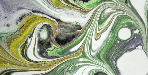 A close up of a painting with green and white colors.