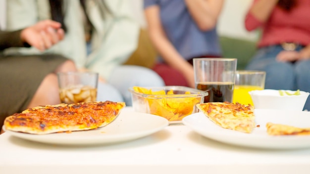 Close up of people eating delivered pizza