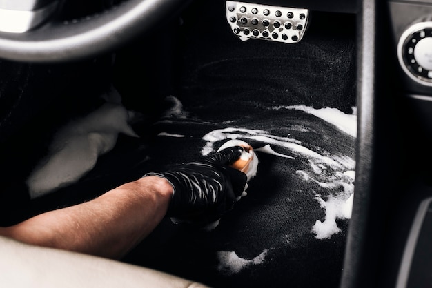 Close up of person cleaning car interior