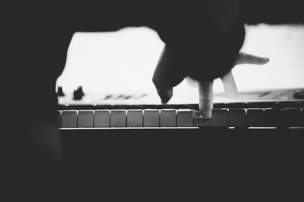 Close-up of person playing piano