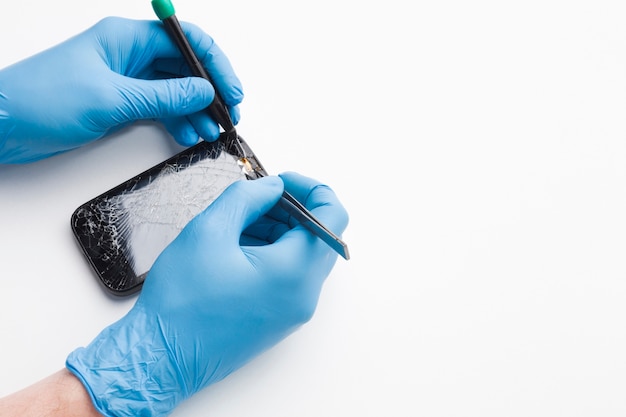 Close-up person repairing a smartphone