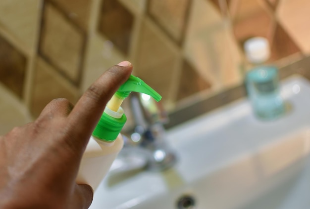 Close-up of person take hand wash