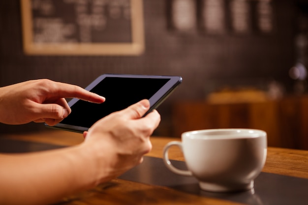 Close-up of person using tablet