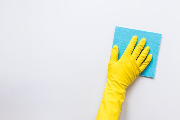 Close-up person with glove wiping surface