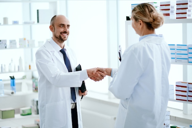 Photo close-up. pharmacy staff greeting each other with a handshake.