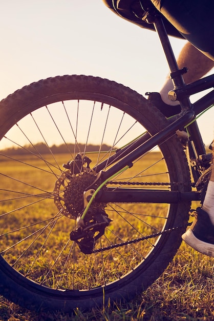 Close-up photo of a cyclist riding a bike on top of a mountain. High quality photo