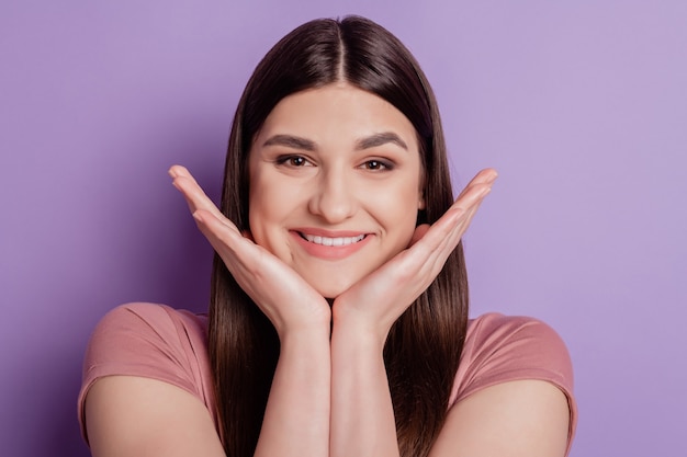 Close up photo of nice attractive girl happy positive smile hands touch chin isolated over violet color background