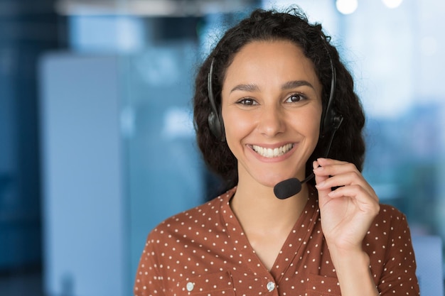 Close up photo portrait of young beautiful hispanic woman business woman smiling and looking at