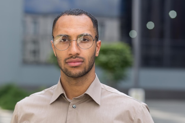 Close up photo portrait of young businessman man in shirt serious and thoughtful man looking at