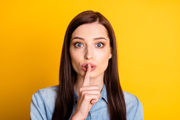 Close up photo of serious girl put index finger lips