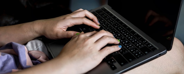 Close-up photo of typing on the keyboard, Asian woman hand typing message on laptop, Laptop typing concept.