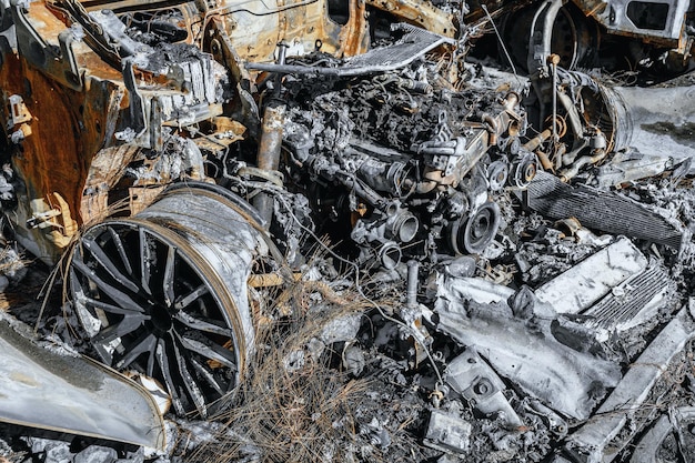 Close up photo of wheel and engine of burned car Arson of a vehicle Insurance case