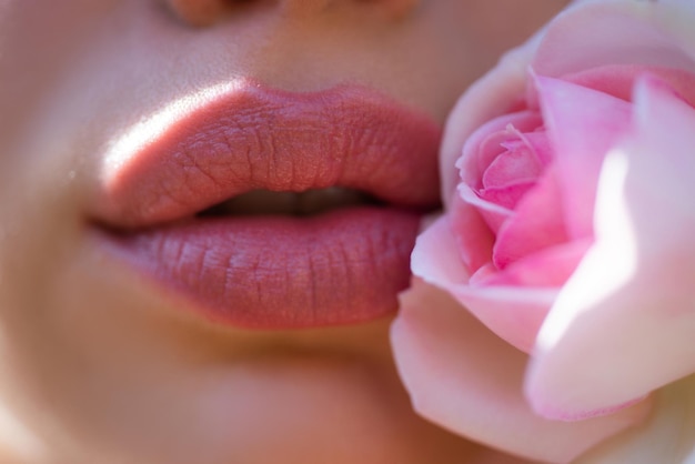 Close up photo of womans lips with natural make up beautiful woman lips with rose