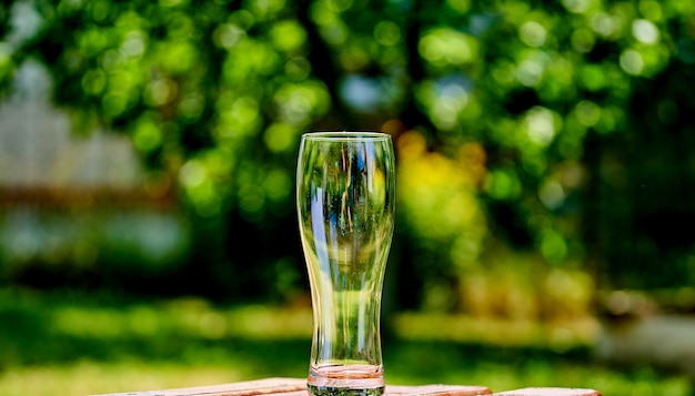 Close-up picture of an ampty beer glass on a brown wooden table.