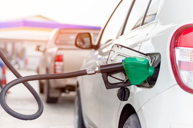 Close up picture of fuel monitoring system refueling a petroleum to vehicle at gas station.