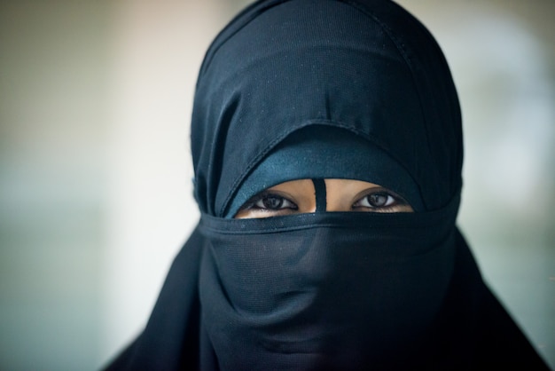 Close up picture of a Muslim woman wearing a black veil