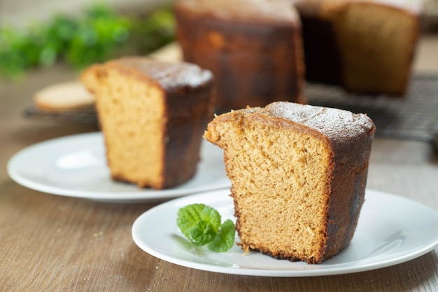 Close up piece of Brazilian corn cake made with a type of corn flour Fuba On a wooden party table Typical sweets of the June festival Cornmeal cake