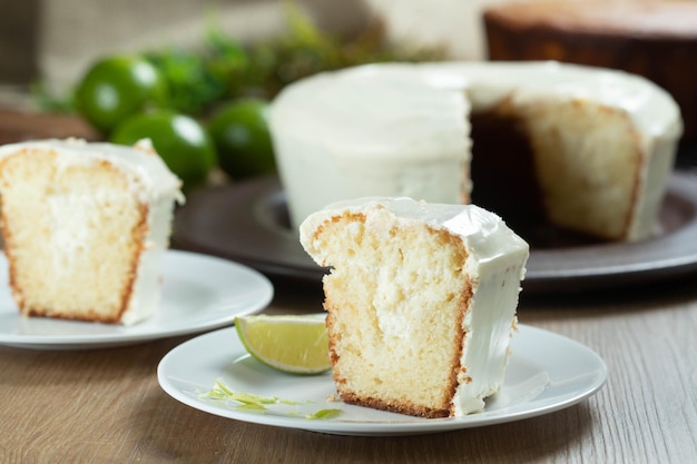 Close up piece of Moist lemon fruit cake on plate with lemon slices on wooden table Delicious breakfast traditional tea time Lemon cake recipe