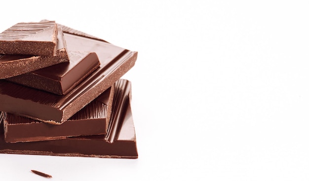 Close up pieces of chocolate on a white background dessert isolated cafe conceptxA