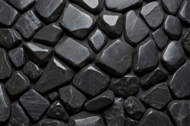 a close up of a pile of black rocks with a white background