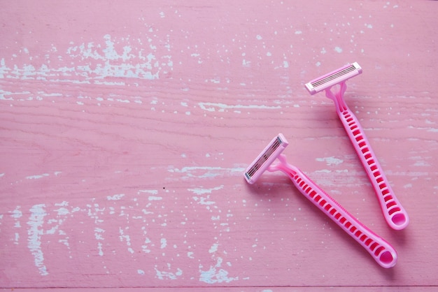 Close up of pink color razor on table