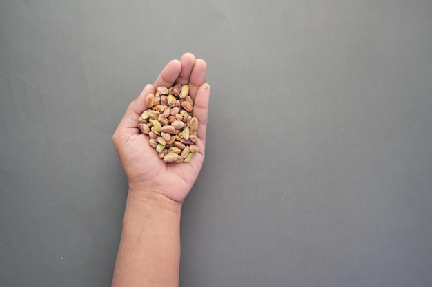 Close up of pistachios nut on hand