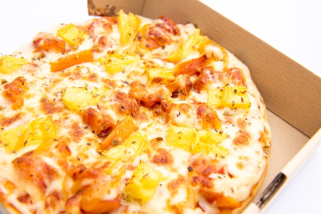 Close up of a Pizza in a cardboard box against on white background
Pizza delivery. Pizza menu.