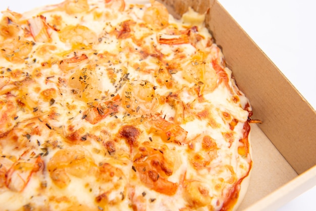 Close up of a Pizza in a cardboard box against on white background
Pizza delivery. Pizza menu.