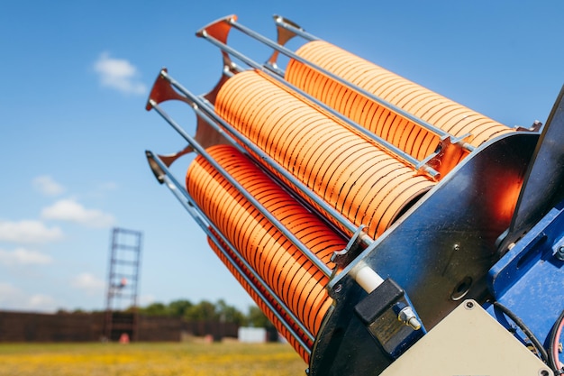 Close up plat machine with orange shooting plate for shootingground training on field with grass