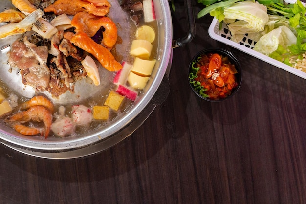 Close up of pook bbq Thai food style shabu sukiyaki or MooKaTa griiled pork Free space for texting