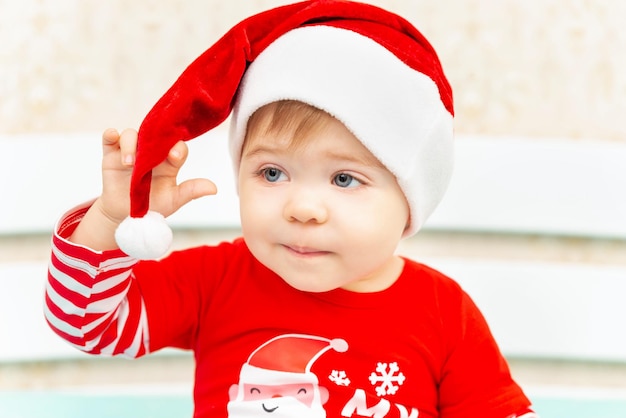 Close up portrait of adorable christmas child in a red hat christmas little baby boy xmas card with