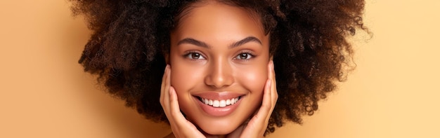 Close up portrait of an African American woman smiling brightly while placing her hands on her face