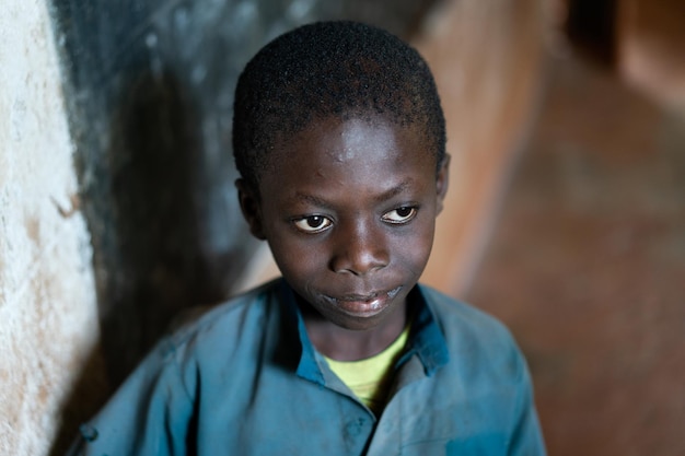 Close-up Portrait of African black Boy portrait inside of school classroom. High quality photo