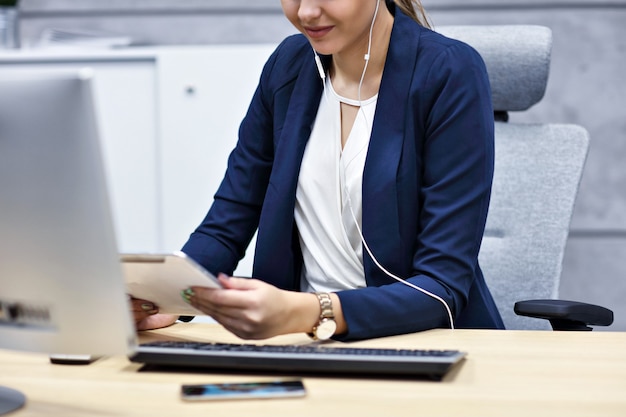 Close up portrait of attractive smiling businesswoman at workplace