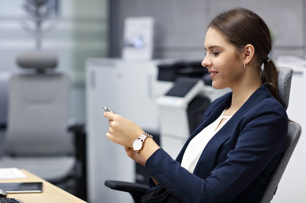 Close up portrait of attractive smiling businesswoman at workplace