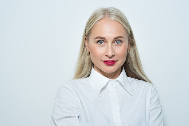 Close-up portrait of a beautiful blonde woman with long smooth hair and blue eyes. casual clothing