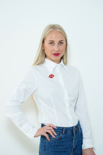 Close-up portrait of a beautiful blonde woman with long smooth hair and blue eyes. casual clothing