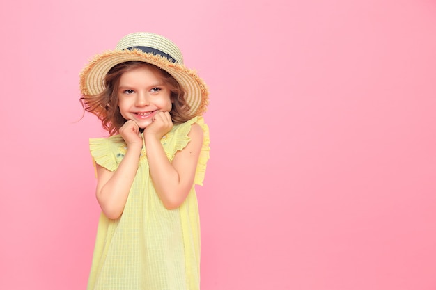 Close up portrait of a Beautiful girl in yellow dress and straw hat.