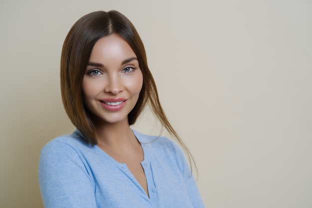 Close up portrait of beautiful lady with beauty face and healthy clean skin, smiles pleasantly