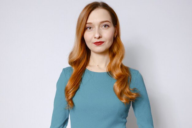 Close-up portrait of a beautiful red-haired woman in a blue dress